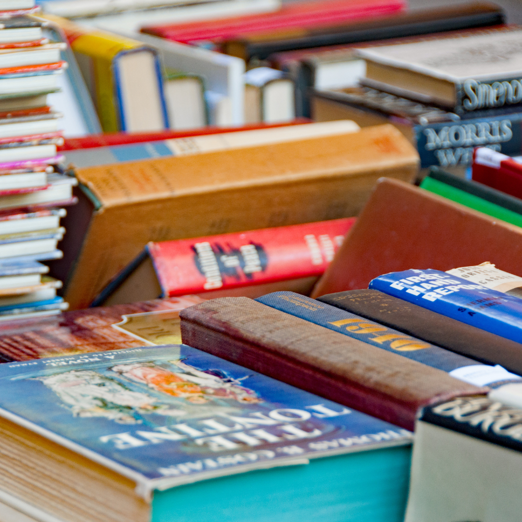 A jumbled selection of books displayed for a sale